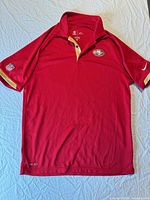 Full front view of red 49ers Nike Dri-FIT polo showing team crest, collar style and overall condition