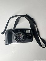 Front view of Pentax Zoom 90 WR camera with strap visible