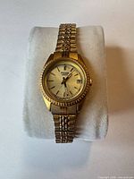 Front view of Pulsar gold-tone wristwatch on cushion