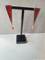 front view of both earrings on stand