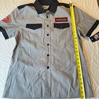 Full front view of gray/black checkered 49ers shirt with measuring tape showing 28-in length