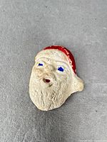 Front view of Santa chalkware brooch showing overall design and wear