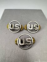 Three U.S. lapel pins front view showing design and wear