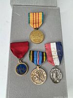 All four medals on display to show fronts and ribbons