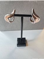 Front view of both earrings on stand showing design and finish