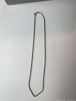 Full view of sterling silver rope chain laid flat