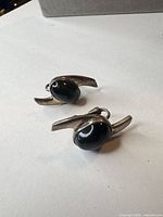 front view of both earrings showing onyx cabochons and sterling frames