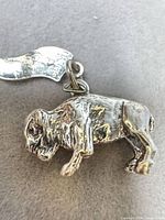 Profile view of sterling silver buffalo charm showing body detail