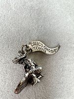 Front view showing banner "Calico Ghost Town" and kneeling miner with pan