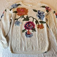 Full view of ivory floral cable knit sweater front