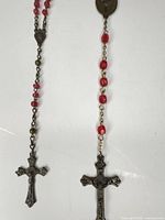 Pair of rosaries showing beads, chain and crucifixes