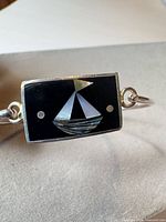 Front view showing sailboat inlay on rectangular plaque