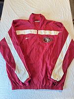 Full front view of Reebok Pro Line 49ers windbreaker jacket laid flat