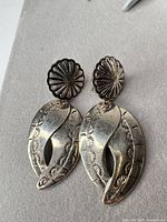 Front view of both clip-on earrings showing overall design and condition