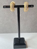 Earrings on stand showing frontal pavé detail