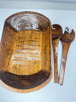 Top view of wooden salad bowl with servers