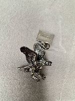 Front view of eagle pendant showing detail and oxidized finish