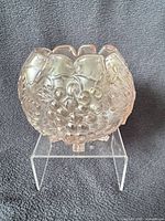 Front view of white carnival glass Grape Delight rose bowl on acrylic stand