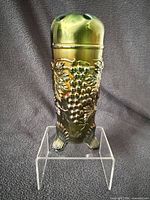 Full front view of green carnival glass hatpin holder on stand