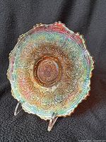 Front view of Fenton marigold carnival glass saucer showing Persian Medallion pattern and iridescence