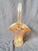 Full view of clambroth carnival glass basket showing handle and body