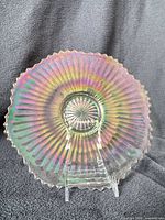 Front view of clambroth carnival glass plate showing Smooth Rays pattern and iridescence
