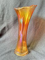 Front view of iridescent marigold carnival glass vase showing ruffled rim and tall form