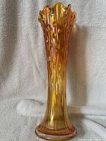 Full side view of iridescent marigold tree trunk vase