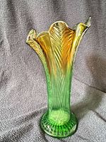 Full view of green carnival glass vase showing color gradient and pattern
