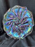 Front view of iridescent Imperial Smoke Acanthus chop plate showing swirl leaf pattern and scalloped rim