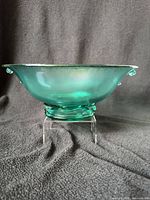 Side profile of teal stretch glass console bowl on stand