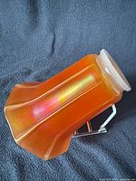 Side view showing marigold iridescence and paneled form