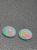 Two oval crystal opals showing play of colour
