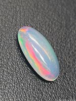 Top view of oval jelly opal showing colour play