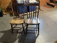 Front view of two spindle-back wooden chairs