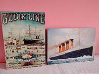 Both tin signs side by side showing size and orientation