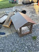 Group including open bird feeder, bat house and additional houses on ground