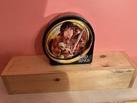 Front view of arch-shaped tin showing character artwork