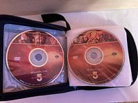 Open zip wallet showing Babylon 5 Season One discs 1 and 2