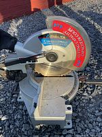 Overall view of Delta compound miter saw on gravel surface