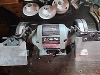 Overall view of the Delta bench grinder with both wheels and eye shields