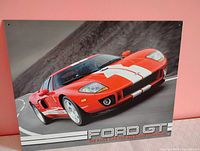 Front view of Ford GT tin sign showing artwork and mounting holes