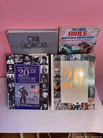 Front view of four books standing upright showing titles and covers