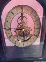 Front view showing entire clock, skeleton movement, Roman numeral dial