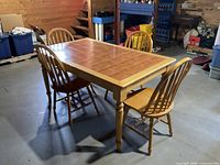 Full view of maple table with tiled top and four chairs