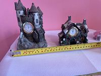 Front view showing both resin clocks and measuring tape for scale