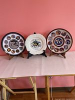 Front view of three Apollo 11 commemorative plates on stands