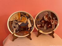 Both Norman Rockwell Mother’s Day plates on stands, front view