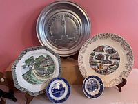 All five plates on display stands