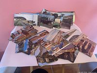 Stacked and spread color photographic postcards front images visible